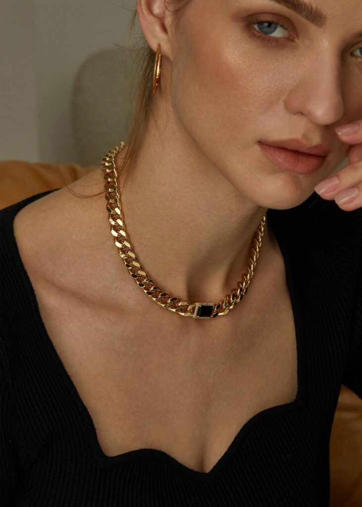 model wearing stainless steel unisex chain necklace in green crystal
