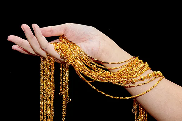 a hand holding some stainless steel chains