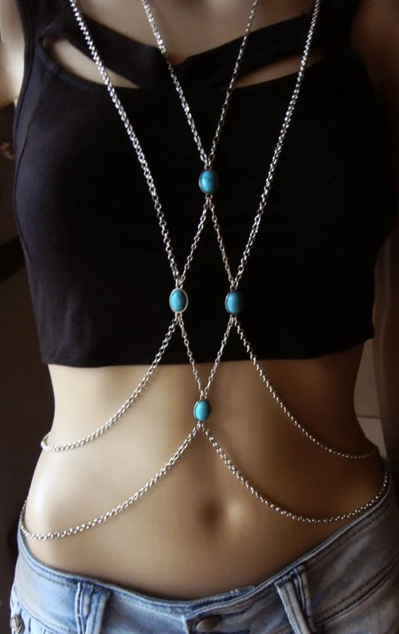 girl in black wearing turquoise body chain