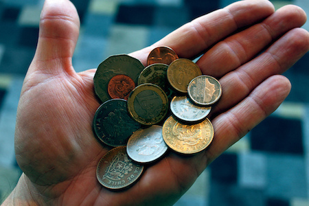 a hand holding some coins