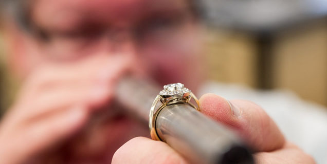 a craftsman using the tool to control the quality of the ring
