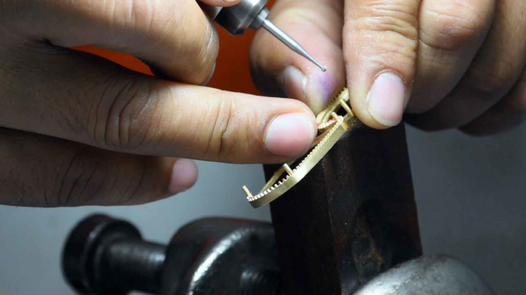 a people repairing the jewelry