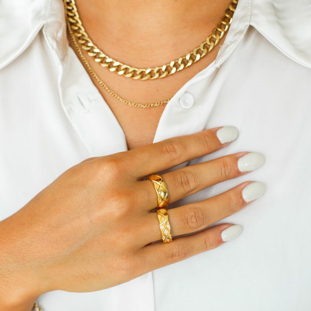 a woman wearing ss necklace and rings