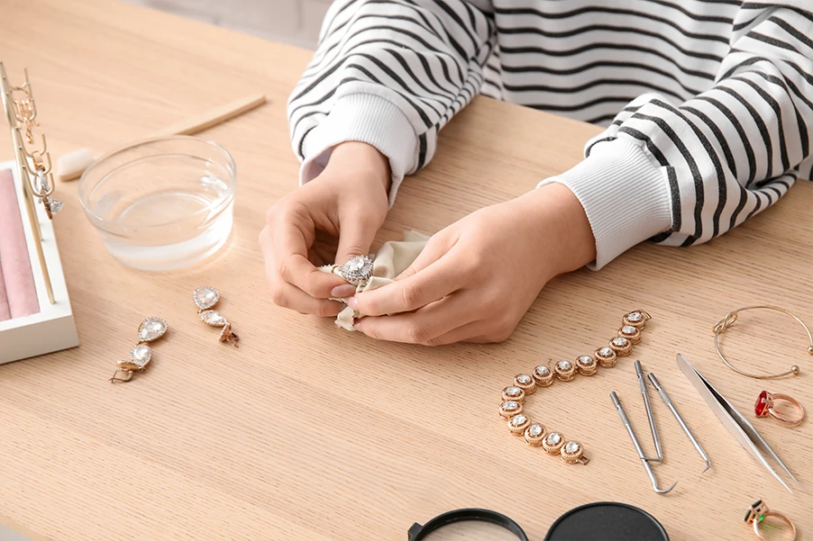 a hand wiping the stainless steel jewelry